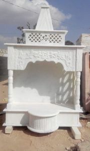 A white, Indian marble pooja temple.