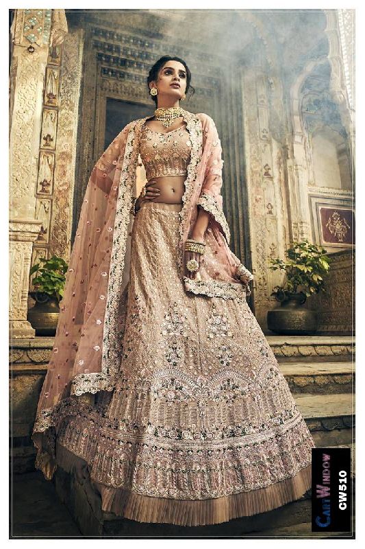 Photo of Bride in light pink and gold lehenga and golden kaleere