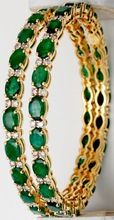 Oval dark green emerald yellow gold bangle