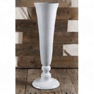 white Cylindrical vase for flowers on table and floor.