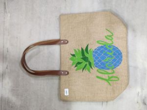 Jute bag with brown rexine handle .