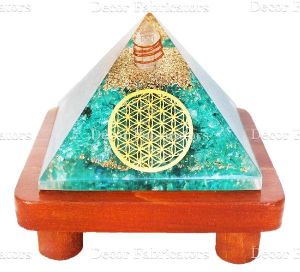 Orgone Light Blue Crystal Stone Vastu Pyramid with Round Healing Symbol on a Brown Wooden Stand