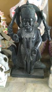 marble shani dev statue with crow