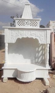 A white, Indian marble pooja temple.