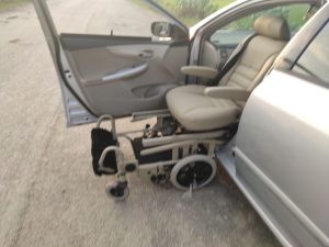 Rotating car seat with wheelchair