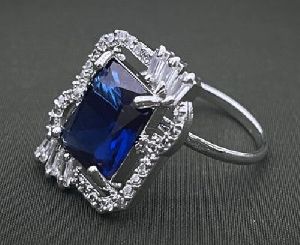 SILVER-PLATED ADJUSTABLE BRASS RING WITH BLUE SAPPHIRE