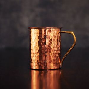 COPPER MUG WITH BRASS HANDLE HAMMERED DESIGN.