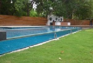 Glass walled swimming pool